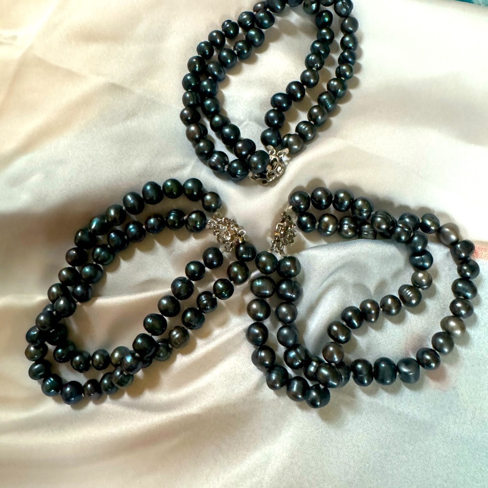 Three peacock pearl bracelets.